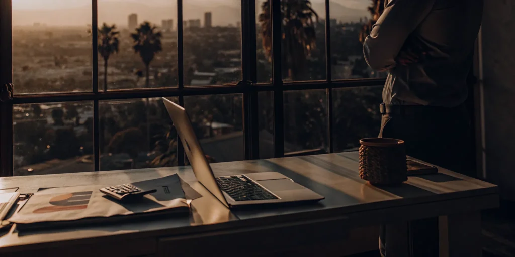 Los Angeles CPA accountant's office with financial documents and a view of the city skyline.