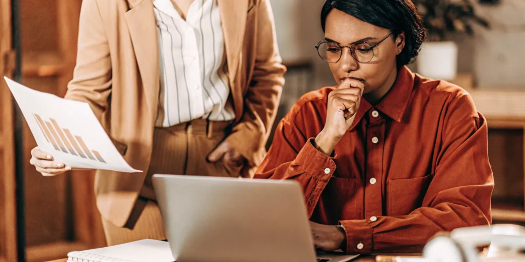 Business owner and CPA consultant reviewing financial reports together at a desk