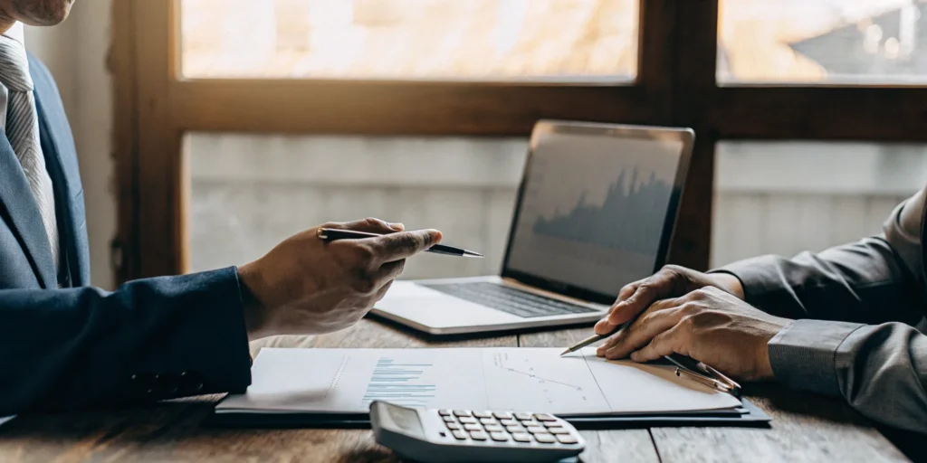 A tax professional helps a client with IRS audit representation by reviewing financial documents.